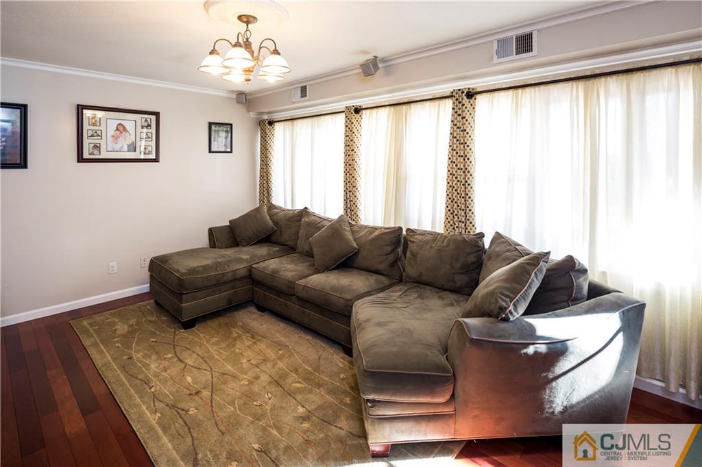 122 Ridge Road Colonia, NJ 07067 - Photo 5 of 25 a living room with furniture and a large window