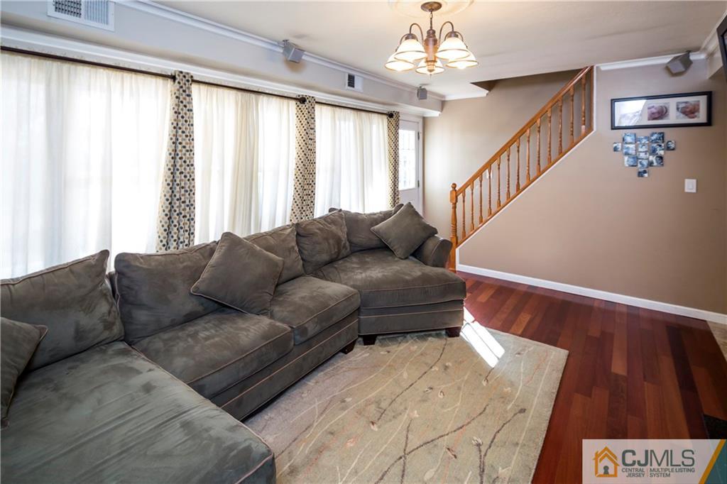 122 Ridge Road Colonia, NJ 07067 - Photo 7 of 25 a living room with furniture and a large window