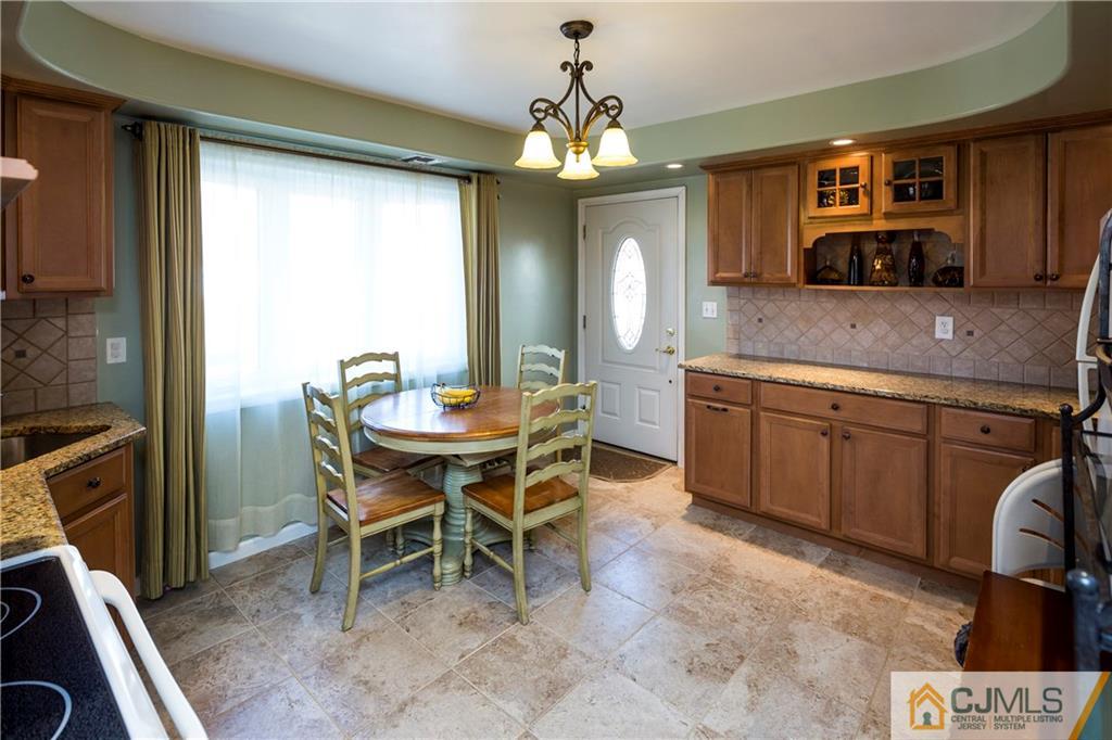 122 Ridge Road Colonia, NJ 07067 - Photo 9 of 25 a kitchen with a table and chairs in it