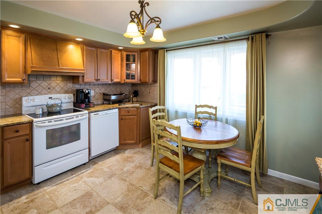 122 Ridge Road Colonia, NJ 07067 - Photo 10 of 25 a kitchen that has a sink and a stove in it