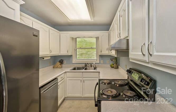 1411 Bailey Branch Road Burnsville, NC 28714 - Photo 11 of 40 a kitchen with a sink stove top oven and cabinets