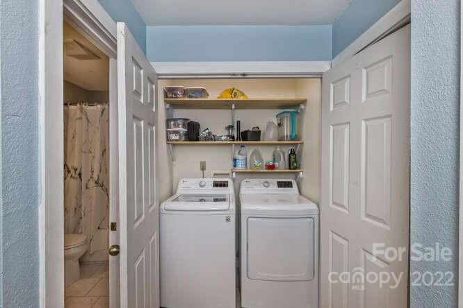 1411 Bailey Branch Road Burnsville, NC 28714 - Photo 13 of 40 a view of washer and dryer with kitchen in the background