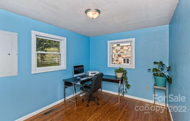 1411 Bailey Branch Road Burnsville, NC 28714 - Photo 14 of 40 a view of a workspace with furniture and a window
