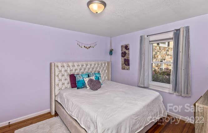 1411 Bailey Branch Road Burnsville, NC 28714 - Photo 16 of 40 a bedroom with a bed and a window