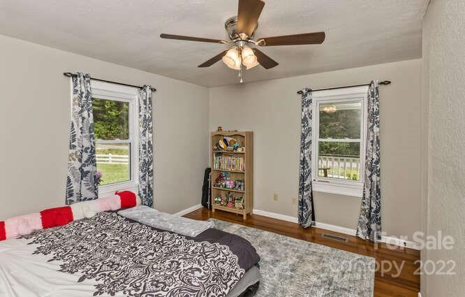 1411 Bailey Branch Road Burnsville, NC 28714 - Photo 18 of 40 a bedroom with a bed dresser and a window