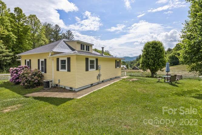 1411 Bailey Branch Road Burnsville, NC 28714 - Photo 25 of 40 a yellow and red house sitting in middle of the grass