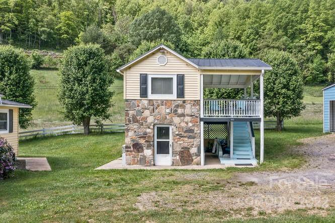 1411 Bailey Branch Road Burnsville, NC 28714 - Photo 26 of 40 a front view of a house with a yard and trees