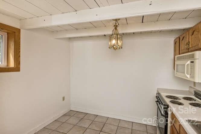 1411 Bailey Branch Road Burnsville, NC 28714 - Photo 28 of 40 a view of a kitchen with storage and utility