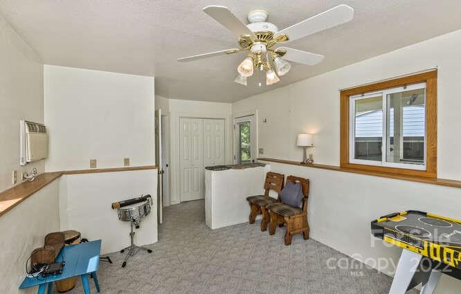 1411 Bailey Branch Road Burnsville, NC 28714 - Photo 30 of 40 a living room with furniture and a chandelier