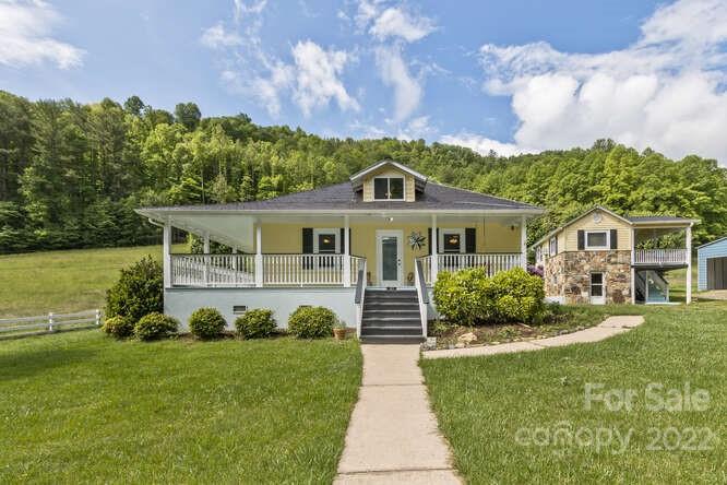 1411 Bailey Branch Road Burnsville, NC 28714 - Photo 3 of 40 a front view of a house with a yard