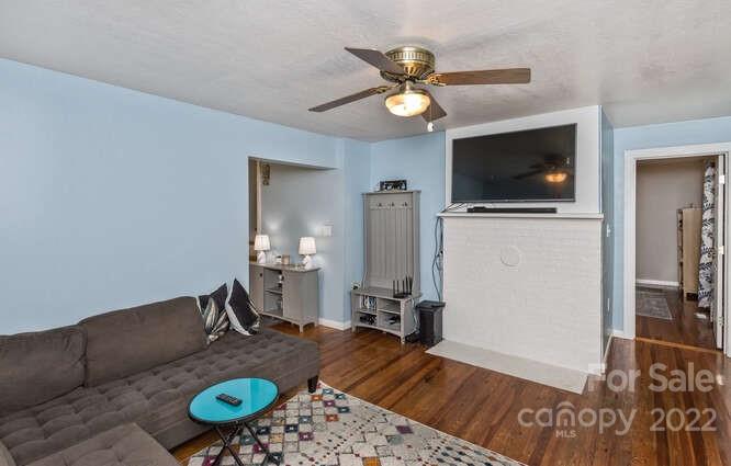 1411 Bailey Branch Road Burnsville, NC 28714 - Photo 8 of 40 a living room with furniture and a flat screen tv
