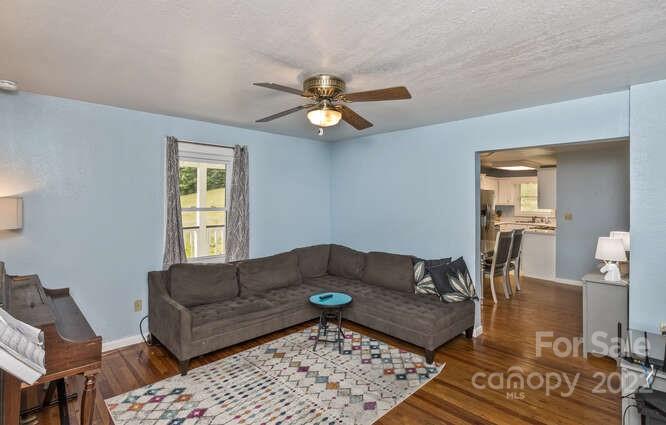 1411 Bailey Branch Road Burnsville, NC 28714 - Photo 9 of 40 a living room with furniture a rug and a window