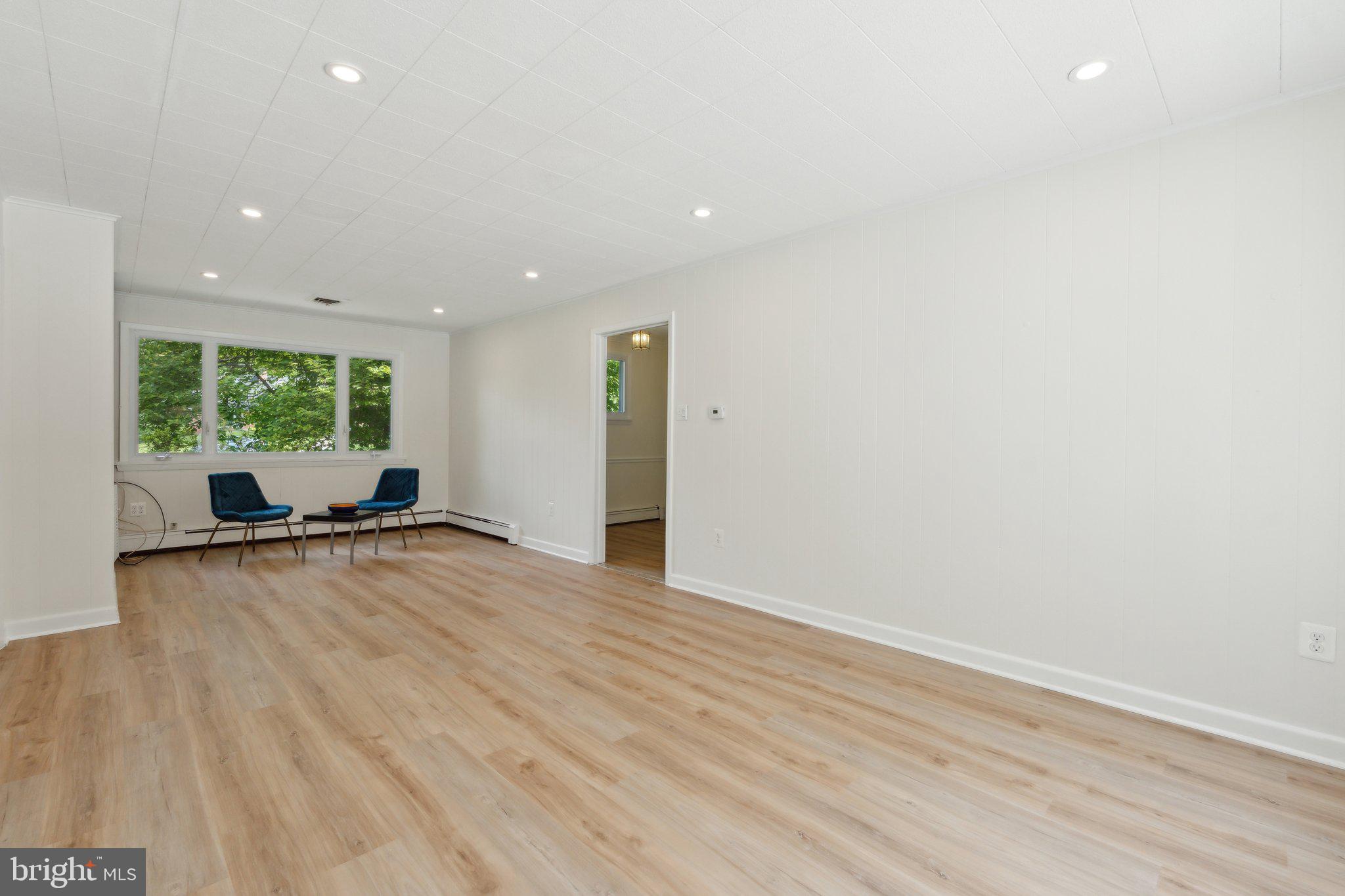 701 Notley Road Silver Spring, MD 20904 - Photo 23 of 60 an empty room with wooden floor and windows