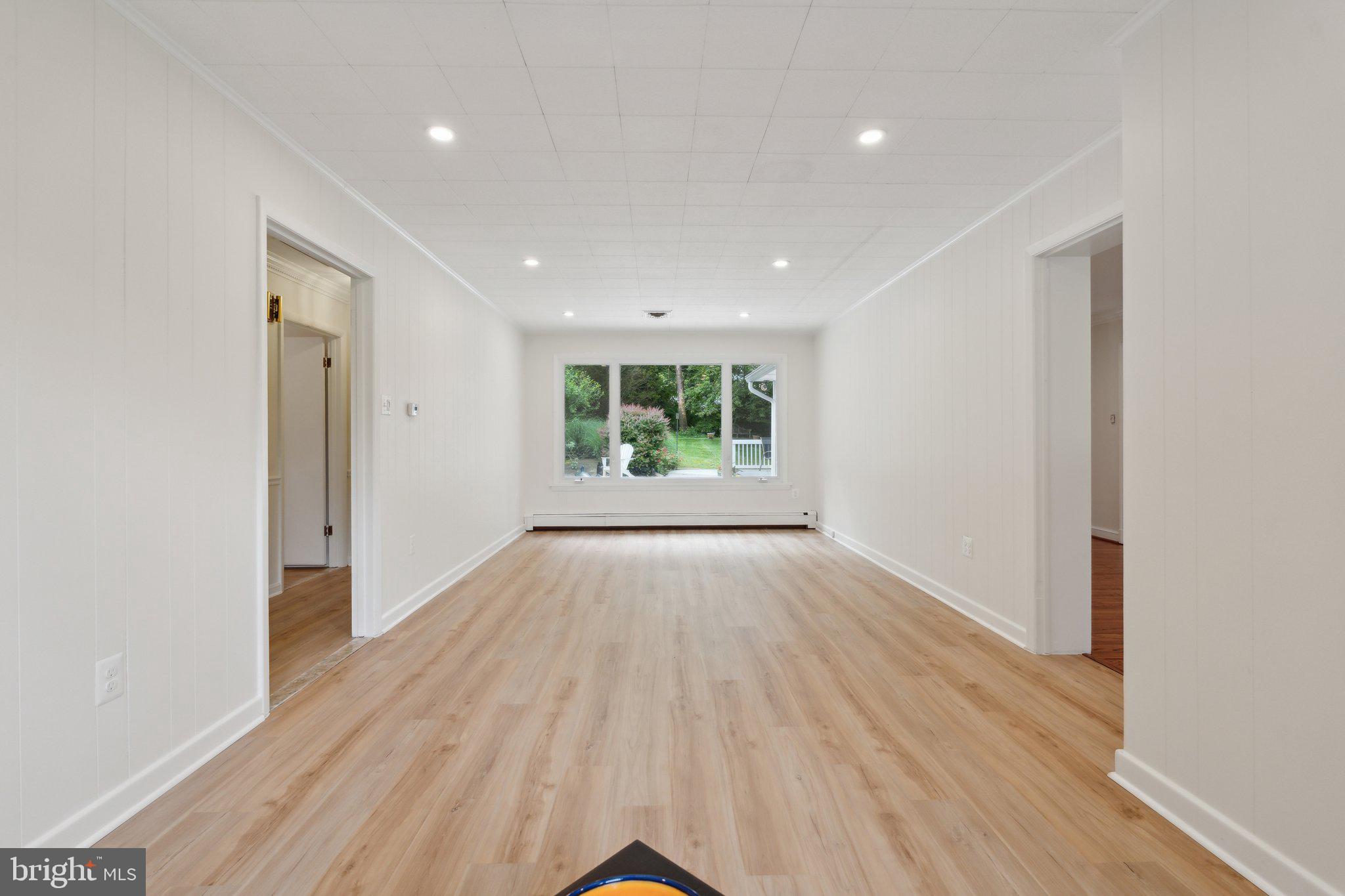 701 Notley Road Silver Spring, MD 20904 - Photo 25 of 60 an empty room with wooden floor and windows