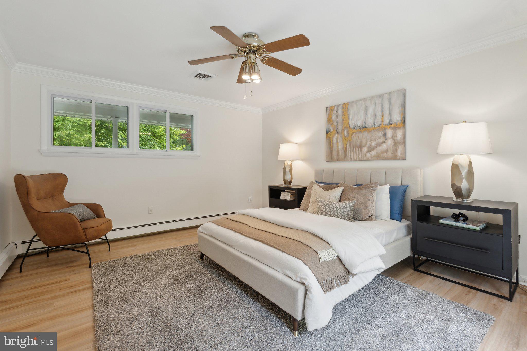 701 Notley Road Silver Spring, MD 20904 - Photo 27 of 60 a bedroom with a bed and a chair