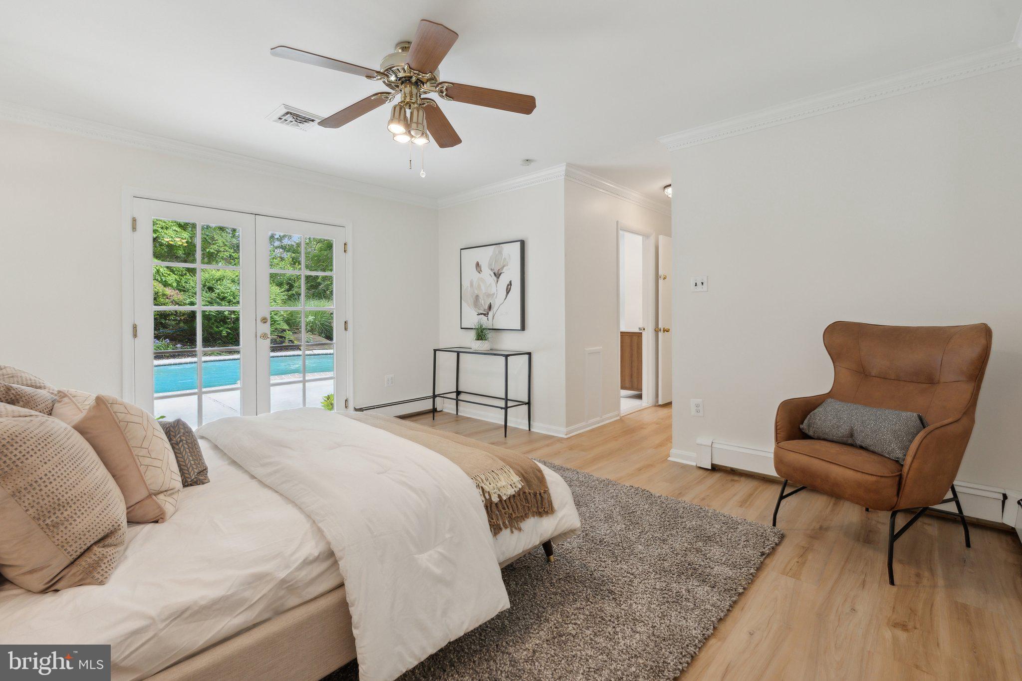 701 Notley Road Silver Spring, MD 20904 - Photo 29 of 60 a spacious bedroom with a bed a couch and a dresser next to a window
