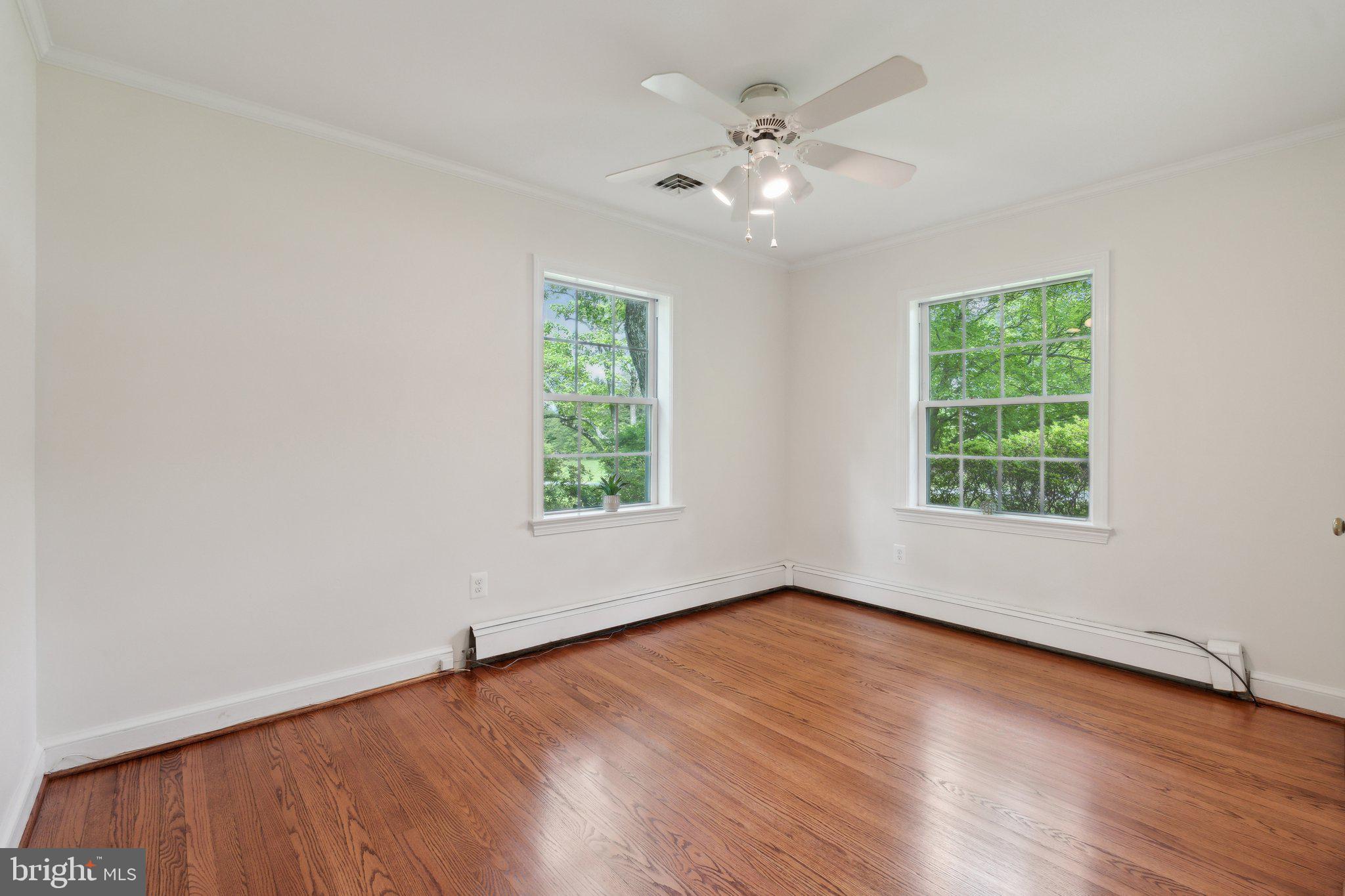 701 Notley Road Silver Spring, MD 20904 - Photo 32 of 60 a view of an empty room with wooden floor and a window