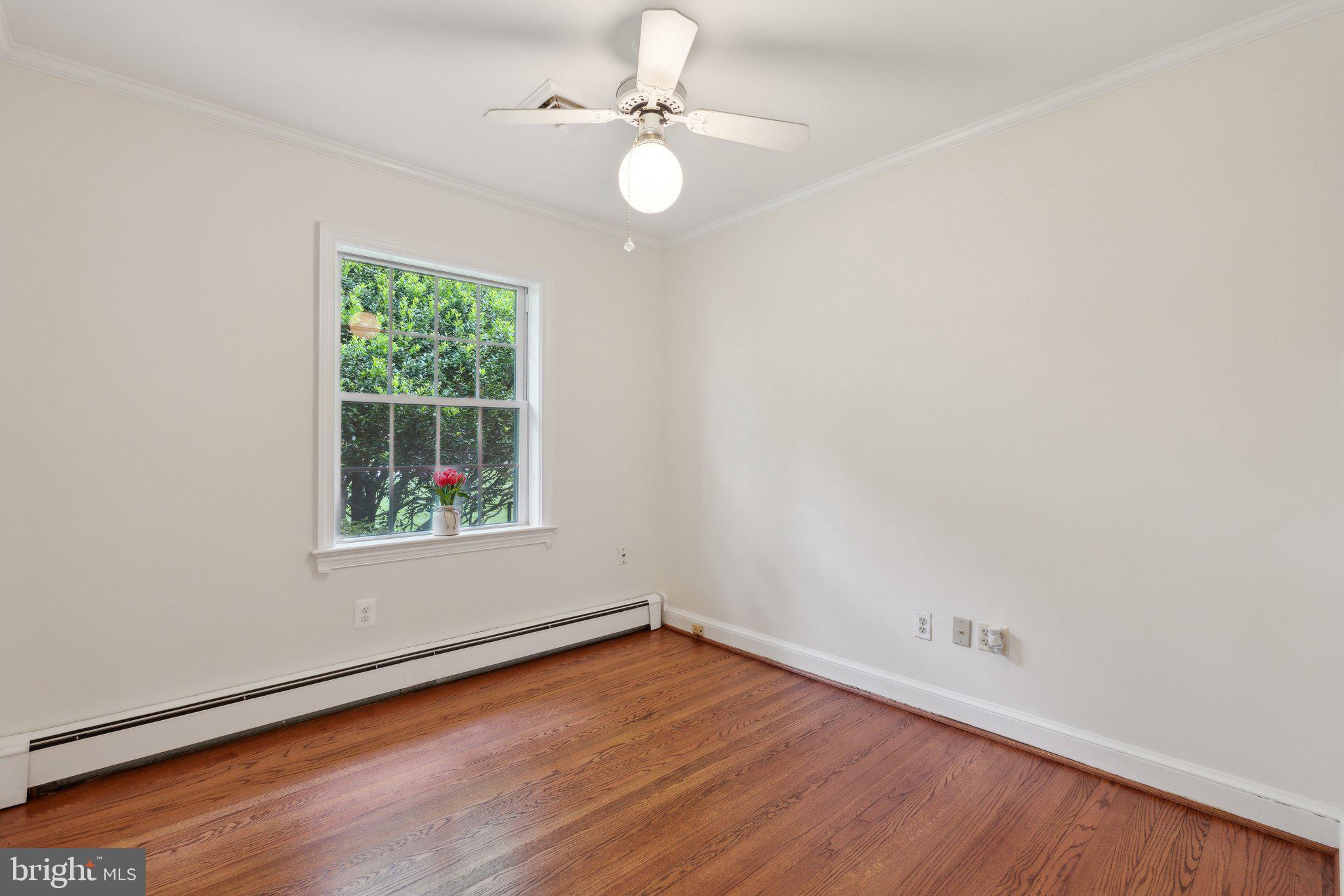 701 Notley Road Silver Spring, MD 20904 - Photo 33 of 60 an empty room with wooden floor and windows