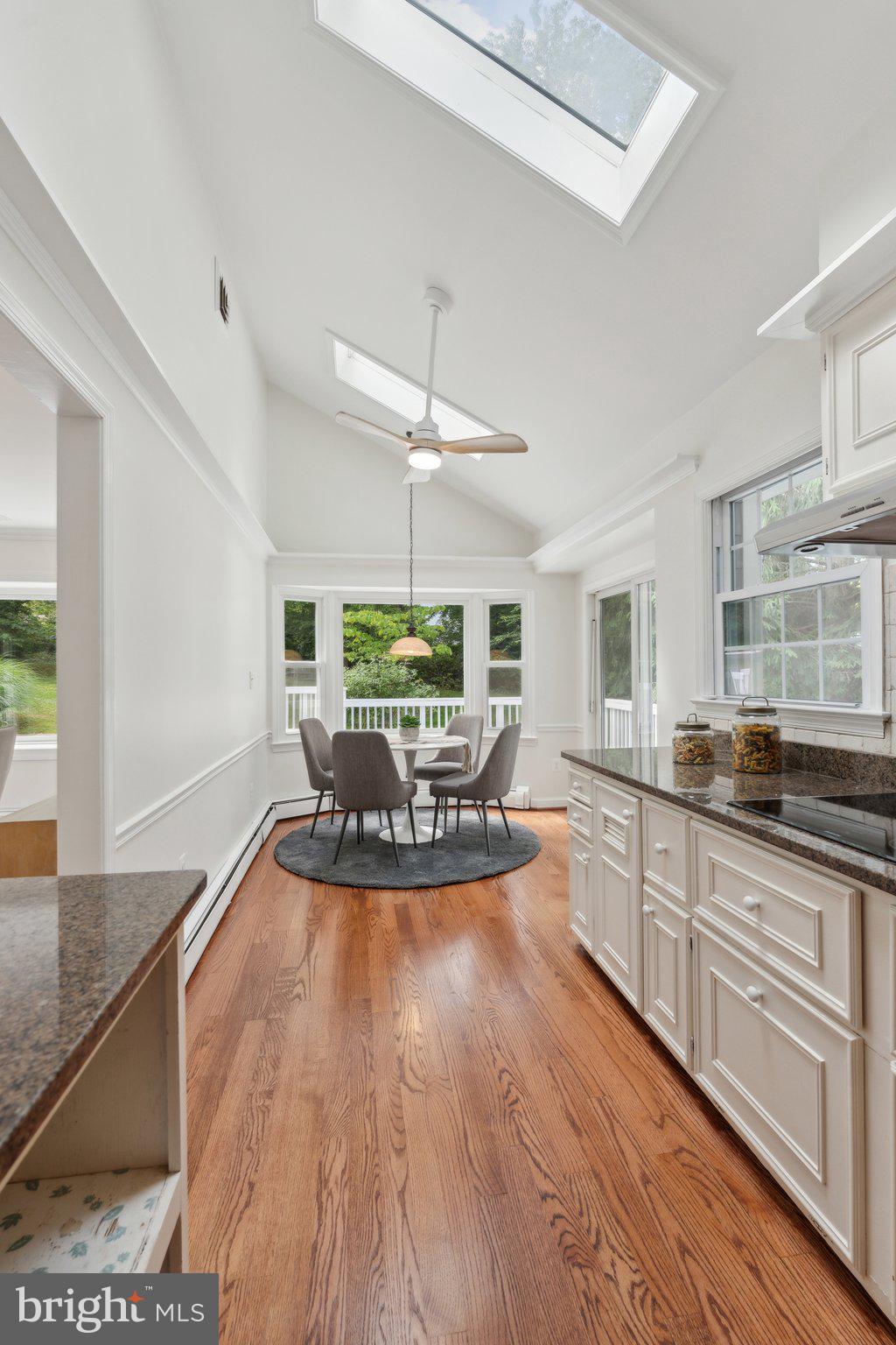 701 Notley Road Silver Spring, MD 20904 - Photo 6 of 60 a large kitchen with stainless steel appliances granite countertop a stove a sink a dining table and chairs with wooden floor