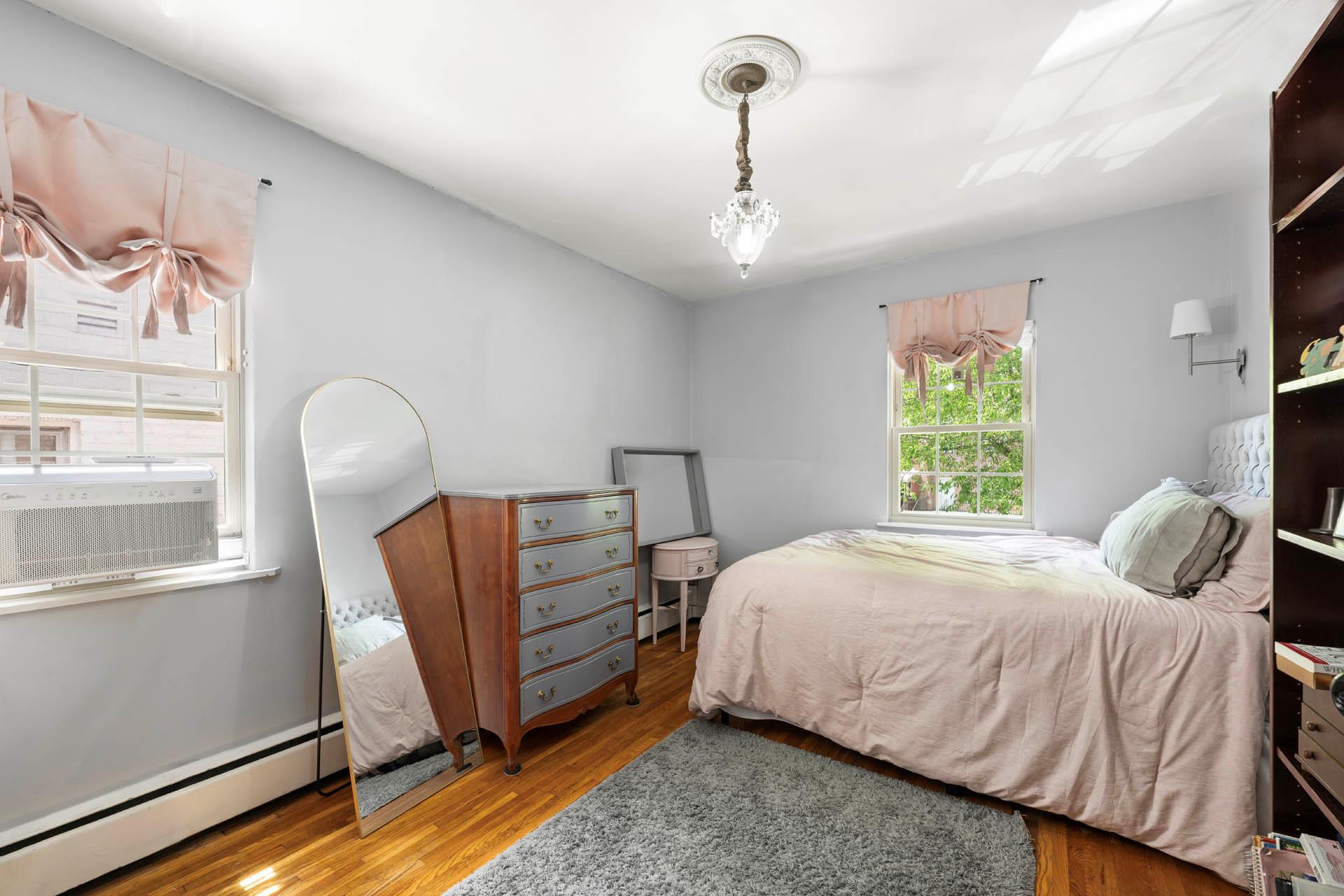 5922 Post Road Bronx, NY 10471 - Photo 11 of 13 Bedroom featuring a baseboard radiator, wood finished floors, cooling unit, and a baseboard heating unit