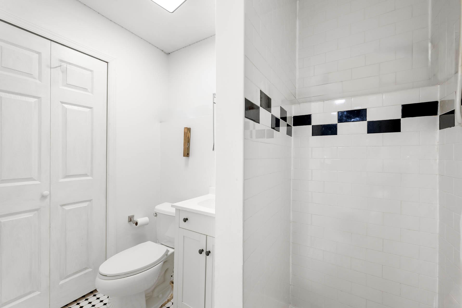 5922 Post Road Bronx, NY 10471 - Photo 12 of 13 Full bath featuring vanity, toilet, a tile shower, and a closet