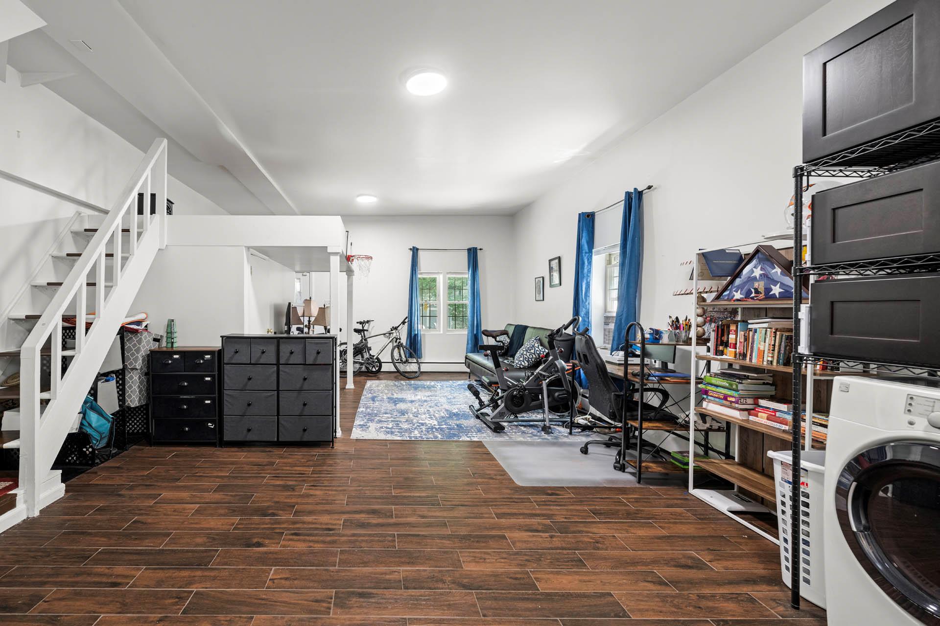 5922 Post Road Bronx, NY 10471 - Photo 13 of 13 Finished Basement featuring washer / dryer, wood finished floors, a baseboard radiator, and recessed lighting