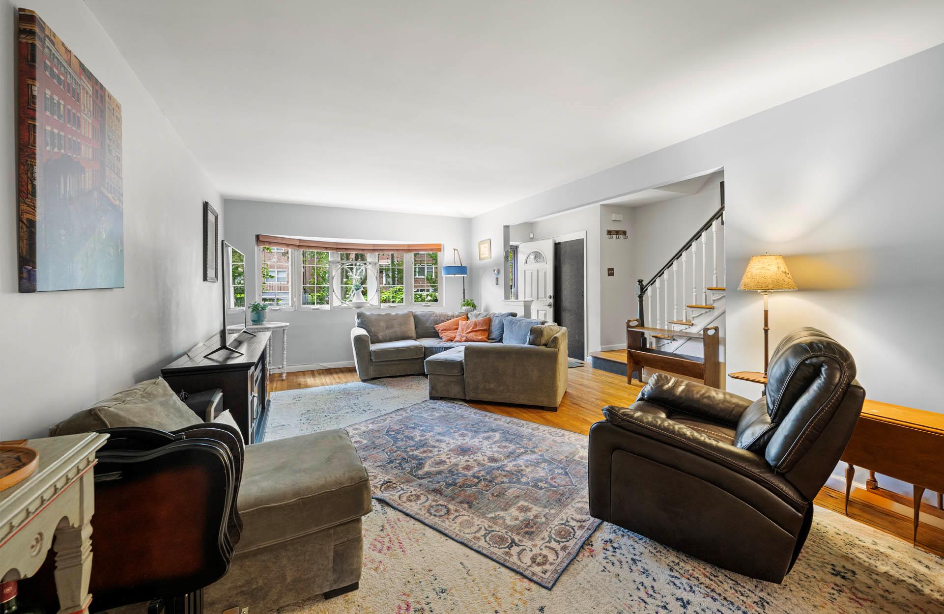5922 Post Road Bronx, NY 10471 - Photo 6 of 13 Living area with wood finished floors, stairs, and baseboards
