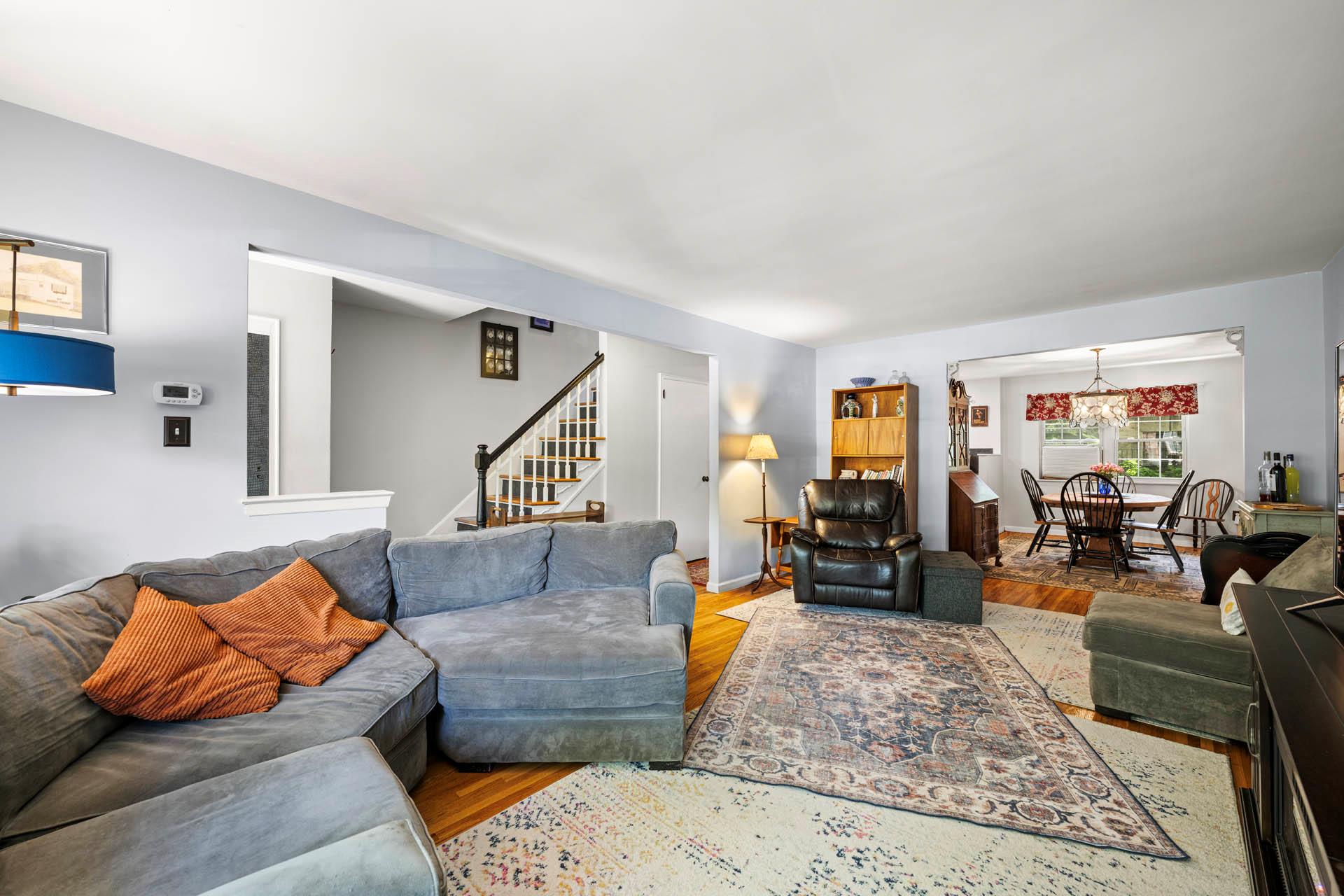 5922 Post Road Bronx, NY 10471 - Photo 7 of 13 Living area with stairs, wood finished floors, and a chandelier