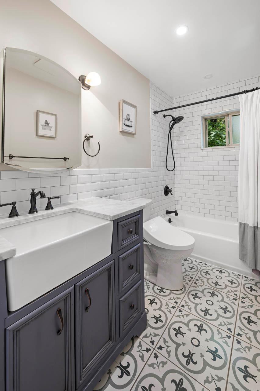 5922 Post Road Bronx, NY 10471 - Photo 9 of 13 Full bath featuring vanity, tile walls, toilet, shower / tub combo, and tile patterned floors