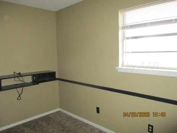 a view of a room with rack on the wall and a window