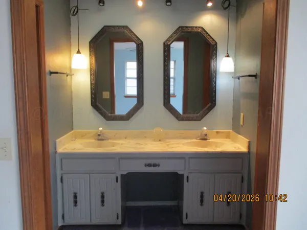 a bathroom with 2 sink and a mirror