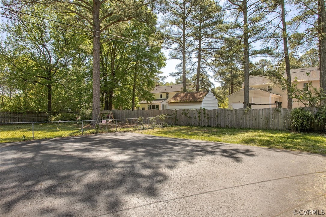 4061 Falstone Road North Chesterfield, VA 23234 - Photo 32 of 33 a view of pool with large trees and wooden fence