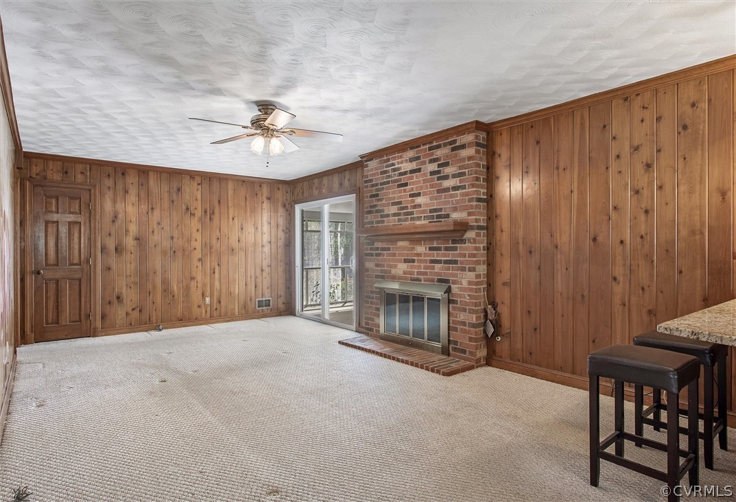 4061 Falstone Road North Chesterfield, VA 23234 - Photo 8 of 33 a view of an empty room with a fireplace and a chandelier fan