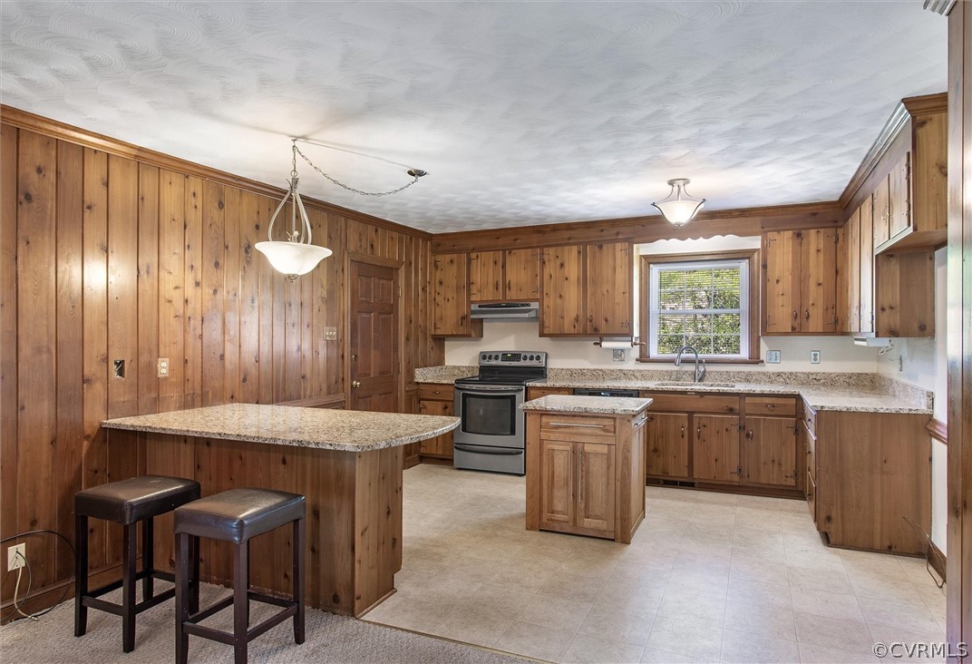 4061 Falstone Road North Chesterfield, VA 23234 - Photo 10 of 33 a kitchen with a stove a sink dishwasher a kitchen island with chairs and wooden cabinets