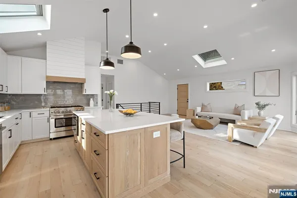 a kitchen that has a lot of cabinets a sink and a stove in it