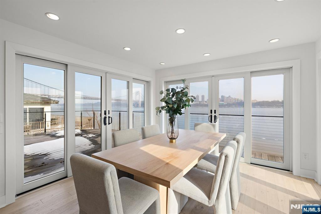 27 Shore Road Edgewater, NJ 07020 - Photo 12 of 48 a view of a dining room with furniture large windows and wooden floor