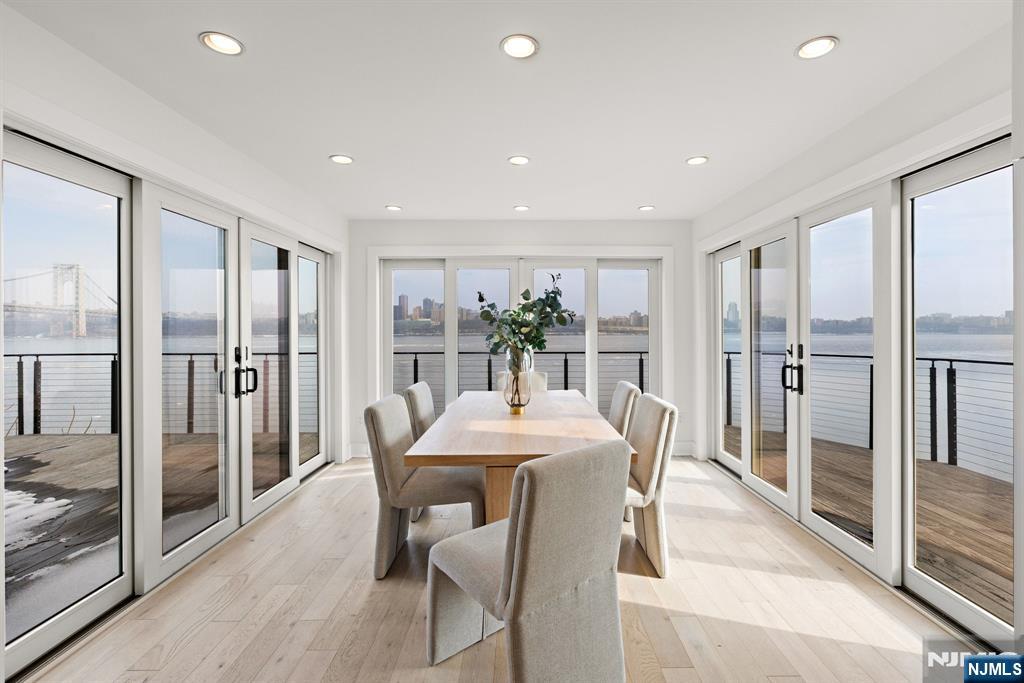 27 Shore Road Edgewater, NJ 07020 - Photo 14 of 48 a dining room with stainless steel appliances granite countertop furniture and a chandelier