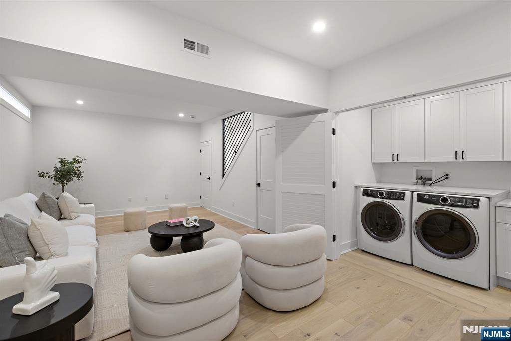 27 Shore Road Edgewater, NJ 07020 - Photo 23 of 48 a living room with furniture and a chandelier