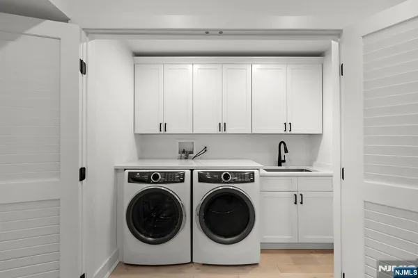 a utility room with sink dryer and washer
