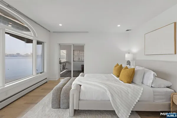a bedroom with a large bed and a large window