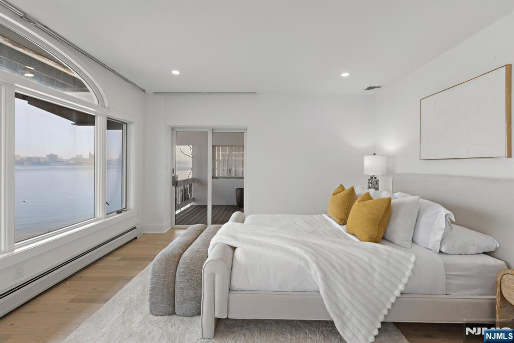 27 Shore Road Edgewater, NJ 07020 - Photo 27 of 48 a bedroom with a large bed and a large window