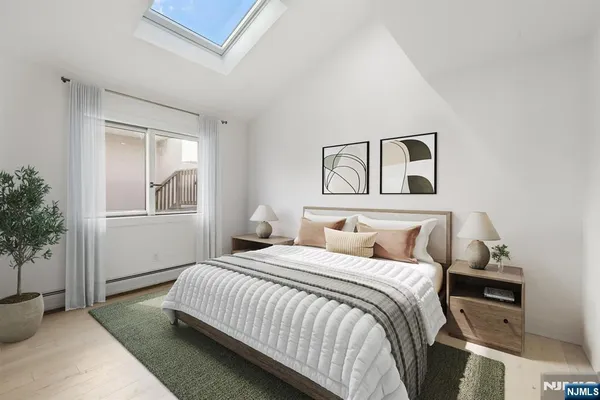 a bedroom with a bed and a painting on the wall