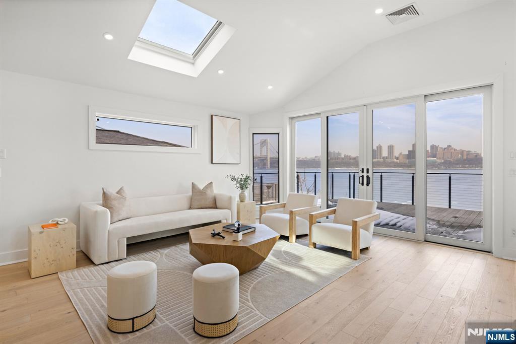 27 Shore Road Edgewater, NJ 07020 - Photo 3 of 48 a living room with furniture and a large window