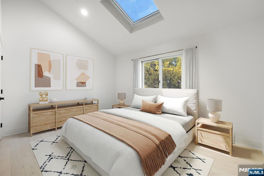 27 Shore Road Edgewater, NJ 07020 - Photo 35 of 48 a bedroom with a bed and a table