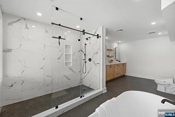 a bathroom with a double vanity sink toilet and shower