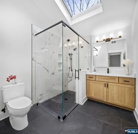 a bathroom with a toilet sink and shower