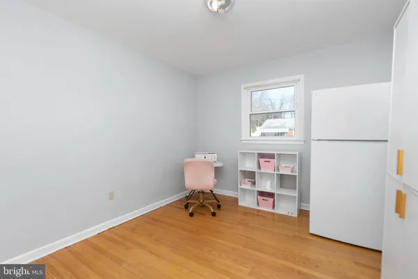 a room with a wooden floor and a window