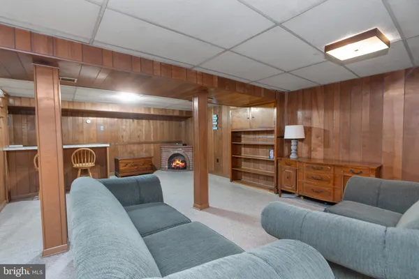 a living room with furniture and a walk in closet