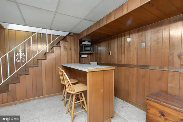 a dining room with wooden floor and chairs