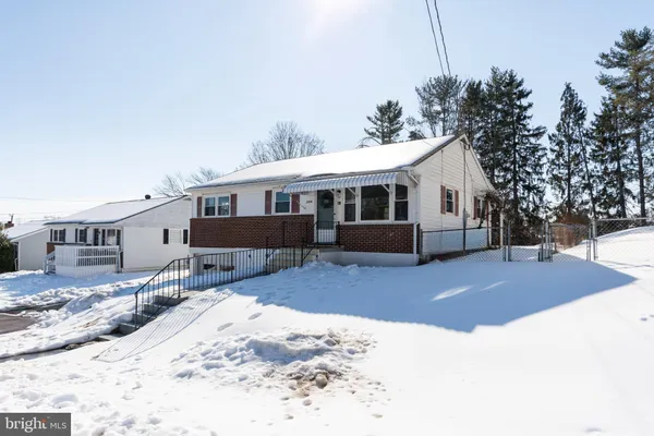 a view of a house with a yard covered in snow
